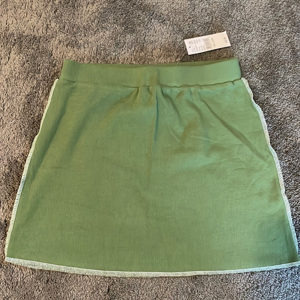 Soft green skirt w/ white side stitching. Elastic band. Never worn